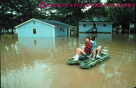 Stock Photo #1324: keywords -  boat boats building buildings damaged disaster disasters flood flooded flooding floods high home homes horz house houses mississippi motorboat neightborhood of people person residential small tupelo victim victims water woman women