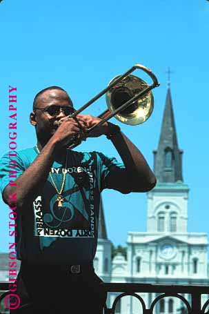 Stock Photo #1362: keywords -  african american art black brass coordination ethnic finger instrument listen louisiana male man music musician new orleans outdoor perform practice skill sound trombone vert wind