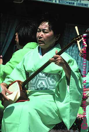 Stock Photo #1364: keywords -  american art asian california coordination ethnic finger francisco instrument japanese listen musician perform practice san stringed vert woman