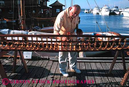 Stock Photo #1386: keywords -  assemble boat build center craft eskimo frame heritage horz kayak kit make man maritime not patience released rib seattle skeleton touch umiak wood work