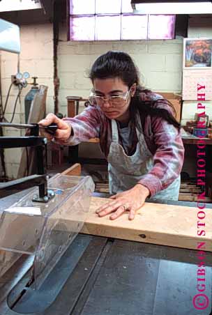 Stock Photo #1388: keywords - blade board careful carefully caution circular commerical craft cut cuts cutting danf=ger dangerous equipment gear glasses guard hand hands hazard hazards in industrial industry job jobs maker occupation occupational pattern protection protective released risky safe safety saw sawing saws sharp shop shops table vert woman wood woodwork woodworker woodworkers woodworking work worker workers working works