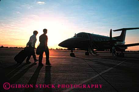 Stock Photo #1430: keywords -  airplane business dawn dusk fly horz jet people small sunrise sunset travel trip walk
