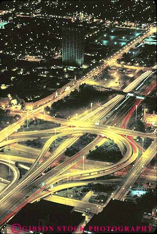 Stock Photo #16051: keywords -  above aerial aerials auto automobiles autos car cars chicago circle circular cloverleaf crossover dark divided down downtown downward drive drives driving elevate elevated evening exchange freeway freeways highway highways hwy illinois interchange interstate lighting lights night overhead pattern patterns pavement road roads round rounded route routes streak streaked streaks street streets system traffic transport transportation travel vehicles vert