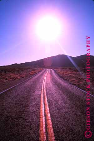 Stock Photo #1486: keywords -  desert drive highway horizon landscape nevada open pavement road route scenic street stripe sun travel vert