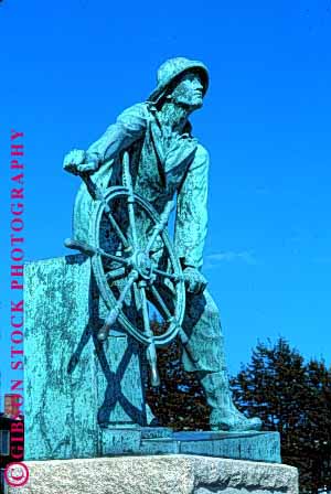 Stock Photo #1588: keywords - commemorate fishermans gloucester lost memorial metal sailor sculpture sea ship statue vert weathered wheel