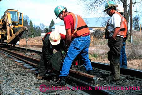 Stock Photo #1629: keywords -  cooperate cut ethnic hardhat heavy hispanic horz industry maintenance men power rail railroad repair saw team track train transportation work