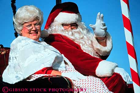 Stock Photo #3530: keywords -  americana cheer christmas claus costume couple holiday horz parade released santa sleigh spirit tradition wave