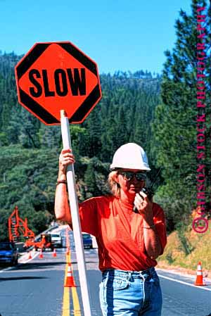 Stock Photo #1751: keywords -  caution communicate construction female flagger hardhat highway job model occupation orange radio released road sign signal slow vert woman work