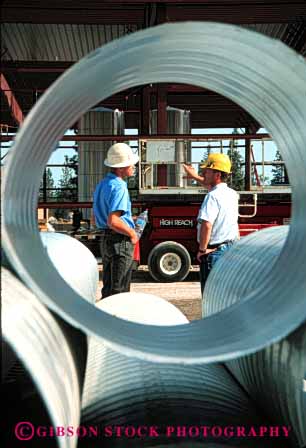 Stock Photo #6040: keywords -  commercial construction hardhat job man men metal pipe plan released round site steel study team together tube tunnel vert work workers working