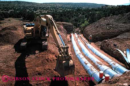 Stock Photo #1769: keywords -  construction cooperate crew culvert dig equipment highway horz install job machine maintenance men pavement pipe team work
