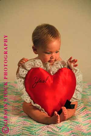 Stock Photo #1786: keywords - baby child cute heart infant model pillow play red released vert yes