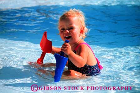 Stock Photo #1792: keywords -  baby child cute happy horz infant model outdoor plastic play pool released smile swim toy water