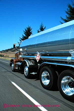 Stock Photo #1818: keywords -  chrome clean commerce explosive flammable industry motion moving over road shiny shipping tank transportation truck trucking vert