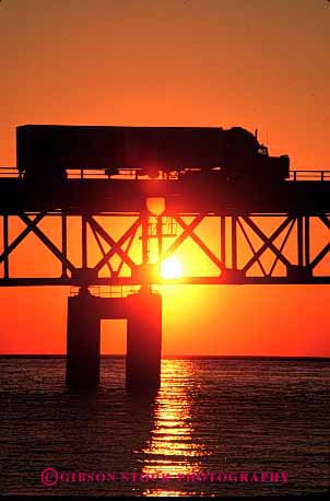 Stock Photo #1823: keywords -  bridge commerce industry mackinac michigan orange shipping silouette sun sunrise sunset transportation truck trucking vert warm