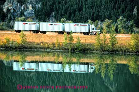 Stock Photo #1835: keywords -  commerce highway highways horz industry interstate motion moving reflection shipping three trailer transportation triple truck trucking trucks