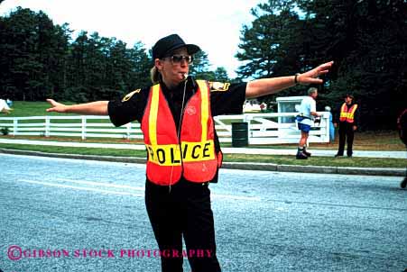 Stock Photo #1849: keywords -  danger direct horz income job occupation policewoman public risk safety service summer traffic uniform vest whistle work