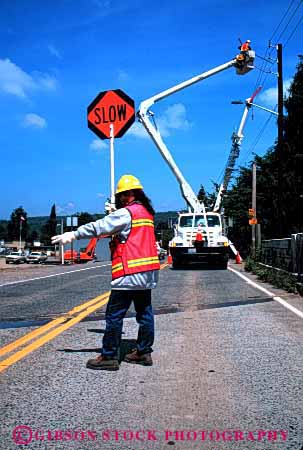 Stock Photo #1853: keywords -  construction control direct hardhat hydraulic industry job occupation orange safety slow team traffic truck utility vert warning woman work