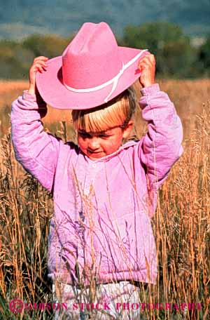 Stock Photo #3340: keywords -  child children cowgirl girl hat outdoors outfit pink released vert west western