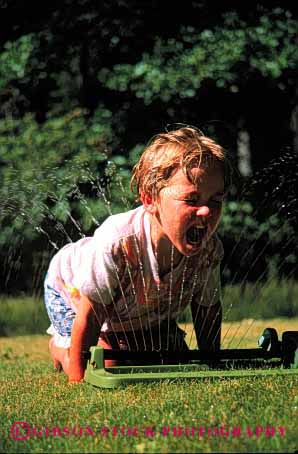 Stock Photo #1882: keywords -  child girl home lawn model play released sprinkler summer vert water