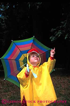 Stock Photo #1883: keywords -  and bright child children coat color colorful colors cute girl girls kid kids material oputdoor outdoor outdoors outside plastic play rain raincoat raining rains released synthetic umbrella umbrellas under underneith vert weather wet yellow