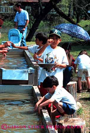 Stock Photo #1886: keywords - boys california children discovery gold hispanic historic history luck marshall metal mineral pan play precious recreation reenact site together vert water