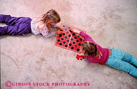 Stock Photo #1895: keywords -  checkers children game girls home horz model pair play relax released safe together