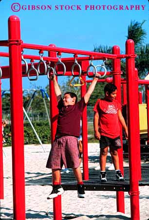 Stock Photo #1901: keywords -  children climb ethnic exercise hang hispanic play playground social together vert