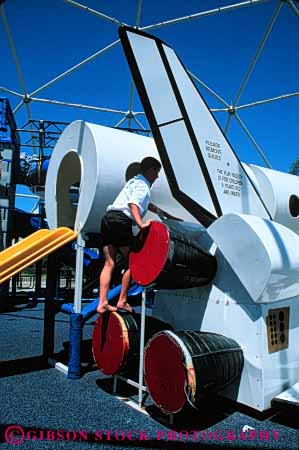 Stock Photo #6095: keywords -  boy center child climb kennedy play playground rocket shuttle space summer theme vert