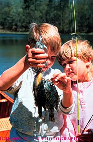 Stock Photo #3345: keywords -  boy children fish fishing girl outdoors play released sport sunfish vert