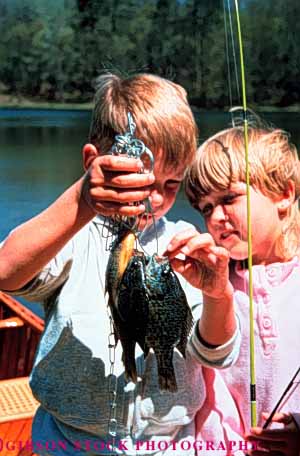 Stock Photo #3345: keywords - boy children fish fishing girl outdoors play released sport sunfish vert