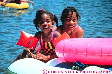 Stock Photo #3347: keywords -  african american beach black children ethnic float girl girls horz lake play released sisters swim