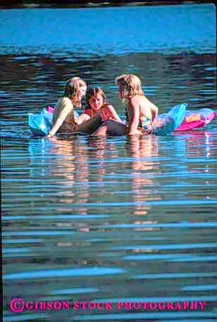 Stock Photo #1913: keywords -  air float girls group lake mat model recreation reflection relax released social summer swim talk together vert water