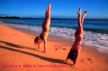 Stock Photo #1917: keywords -  balance bathing beach down girls gymnastic handstand horz model ocean play recreation released sand suit summer upside vacation warm