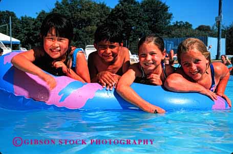 Stock Photo #1919: keywords - asian boy children ethnic girl group hispanic horz japanese mixed model pool raft recreation released smile summer swim together water