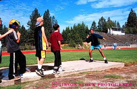 Stock Photo #6042: keywords -  and athlete athletic attempt black boy child children class competition contest effort elementary field girl grade horz practice put school shot sport strength together track try