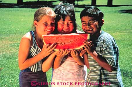 Stock Photo #3354: keywords -  asian boy boys children cooperation eat eating eats ethinc ethnic food friend friends friendship fun gender genders girl girls group happiness happy hispanic hold holding holds horz japanese kid kids mexican minority mixed outdoor play playing recreation released share shares sharing smile smiles smiling summer three together watermelon