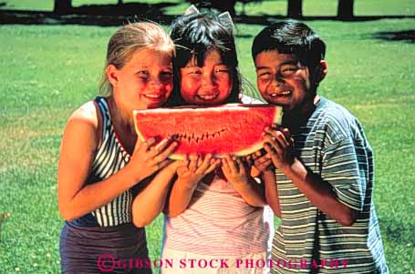 Stock Photo #3354: keywords - asian boy boys children cooperation eat eating eats ethinc ethnic food friend friends friendship fun gender genders girl girls group happiness happy hispanic hold holding holds horz japanese kid kids mexican minority mixed outdoor play playing recreation released share shares sharing smile smiles smiling summer three together watermelon