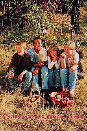 Stock Photo #1930: keywords -  adolescent adolescents african american apple apples autumn black boy boys child children eat eating eats ethnic fall food four friend friends friendship fruit gender girl girls group groups happy mixed model orchard released sit sits sitting smile smiles smiling together vert youth