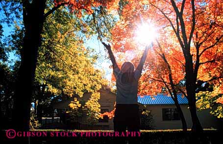 Stock Photo #1958: keywords -  arms autumn bright embrace fall foliage girl horz landscape model nature orange outdoor released scenic silouette sun sunshine