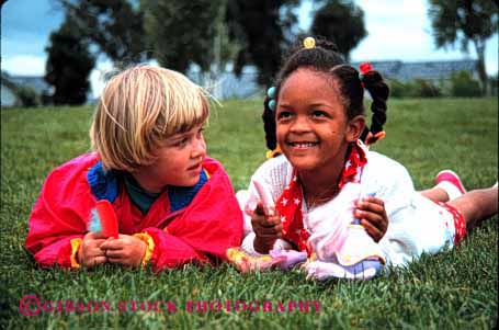 Stock Photo #1994: keywords -  african american black doll ethnic friend girls grass group happy horz lawn mix model outdoor play recreation released share smile social
