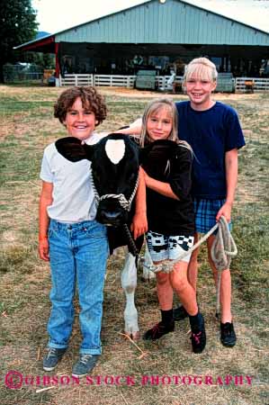 Stock Photo #1999: keywords -  affection animal boy child children cow fair girl happy livestock love not released show summer team touch vert