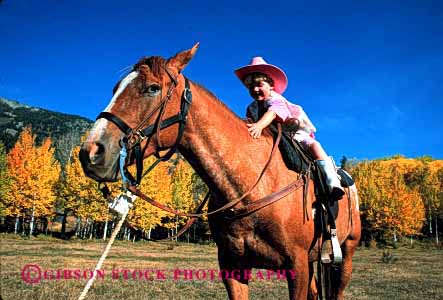 Stock Photo #2005: keywords -  affection animal child costume cowgirl girl happy horse horz love not pet released ride team touch