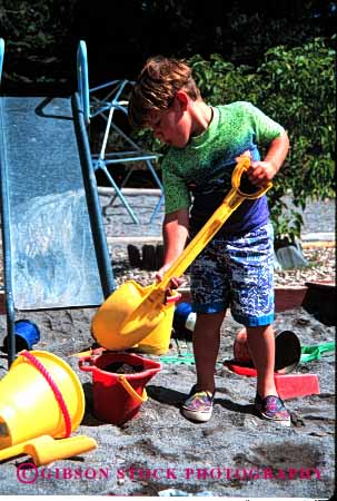 Stock Photo #2014: keywords -  boy boys child children daycare development dig digger digging digs education in learn play playground playgrounds playing plays preschool released sand shovel social summer teach toy toys vert youth