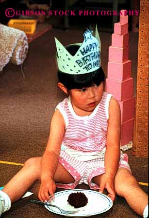 Stock Photo #2016: keywords -  asian birthday cake celebrate celebrates celebrating child children crown daycare development eat eating education ethnic floor girl hat japanese kid kids learn minority model play playing plays preschool released sits sitt sitting social teach vert