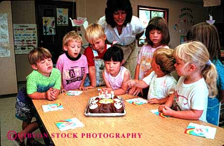 Stock Photo #2018: keywords -  adult birthday boy boys cake cakes celebarte celebartes celebrate celebrating child children daycare development education ethnic gender genders girl girls group groups having horz kid kids learn minority mixed multi parties party play playing plays presch preschool released social teach teacher with