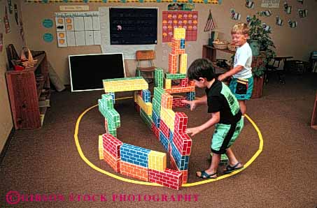 Stock Photo #6089: keywords -  adolescence adolescent block blocks boy boys build building builds child children class construct cooperate cooperates cooperating daycare game games group horz kid kids learn play playing plays practice preschool released school stack stacked stacking stacks team teamwork together two young