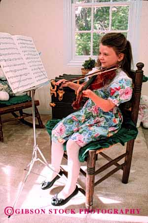 Stock Photo #2023: keywords -  child children cute girl girls home instrument instruments kid kids lesson lessons music musical musician play playing plays practice practices practicing released sit sitting skill sound st string stringed vert violin violins youth