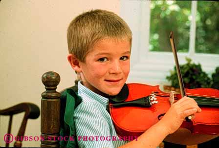 Stock Photo #2027: keywords -  boy boys child children cute home horz instrument instruments kid kids lesson lessons musical musician play playing plays practice practices practicing released sit sitting skill smile sound string stringed violin violins youth