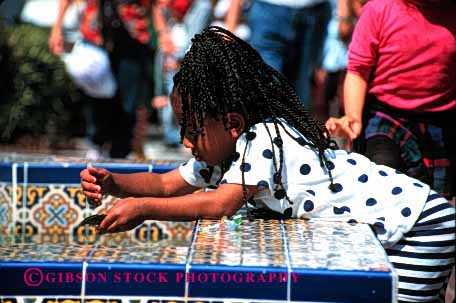 Stock Photo #2060: keywords -  african american black child ethnic fountain game girl healthy horz not outdoor play released water