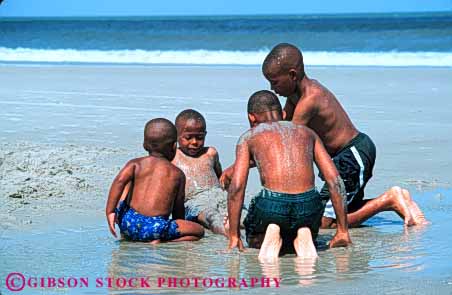 Stock Photo #6087: keywords -  adolescence adolescent african american beach black boy boys child children ethnic four group horz minority ocean outdoor play race sand shore summer together water young
